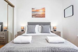 a bedroom with a large bed with two pillows at No1 Coppergate - Donnini Apartments in Prestwick