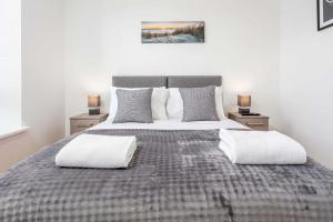 a bedroom with a large bed with two night stands at No1 Coppergate - Donnini Apartments in Prestwick