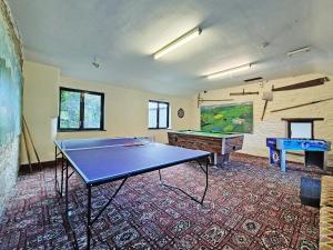 a ping pong room with a ping pong table at Whortleberry Cottage in Wheddon Cross