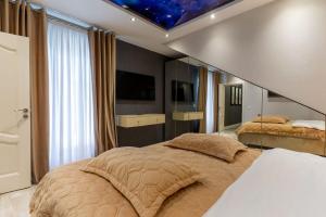 a bedroom with two beds and a star ceiling at Complex Rediu 54-PentHouse in Rediu