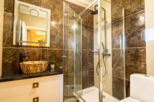 a bathroom with a shower and a toilet and a sink at Complex Rediu 54-PentHouse in Rediu +65 photos