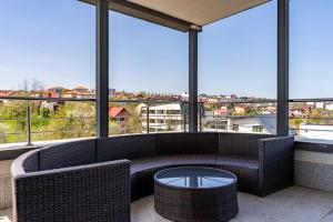 a room with a couch and a table and windows at Complex Rediu 54-PentHouse in Rediu