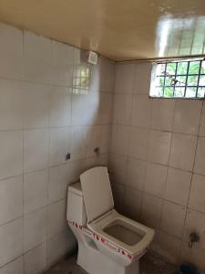 a dirty bathroom with a toilet and a window at Green bell male dormitory in Bhopal +12 photos