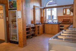 a kitchen with wooden cabinets and a refrigerator at juhui Arosa in Arosa +32 photos