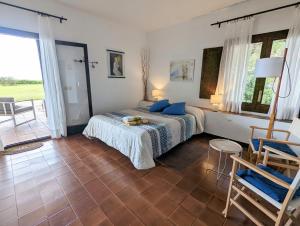 a bedroom with a bed with blue pillows on it at El setè cel in Malgrat de Mar
