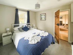 a bedroom with a bed with towels on it at Craigrannoch Cottage in Rockcliffe