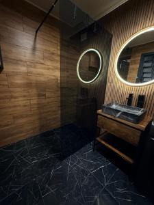 a bathroom with a sink and a mirror at Stone & Soul House in Chernihiv