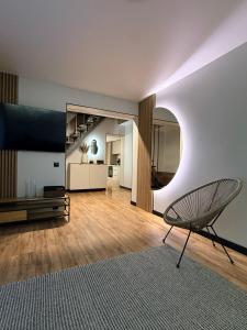 a living room with a chair and a large mirror at Stone & Soul House in Chernihiv +19 photos