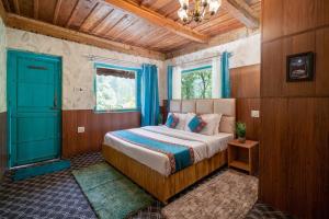 a bedroom with a bed and a blue door at Havana stays in Shoja