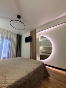 a bedroom with a large bed and a mirror at Stone & Soul House in Chernihiv