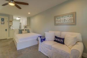 a living room with a couch and a bed at 104 Inlet Sands Condo in Inlet Beach