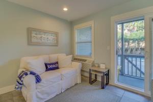 a living room with a white couch and a window at 104 Inlet Sands Condo in Inlet Beach