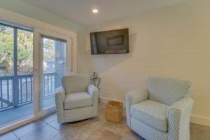 a living room with two chairs and a balcony at 104 Inlet Sands Condo in Inlet Beach +20 photos