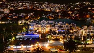 an aerial view of a large house at night at The Bay Hotel in Cape Town +151 photos