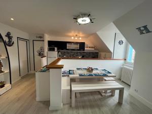 a kitchen with a table and a counter top at Les Roitelets "MARINE" Appartement T4 Duplex 80m2 - Thème Marin - Entièrement NEUF - Classé 3 étoiles - Proche Centre-ville & Thermes - Tout Confort - Ménage et Linge de maison INCLUS in La Bourboule +32 photos