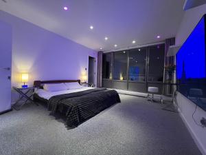 a bedroom with a large bed and a large window at The London Skyline Penthouse in London