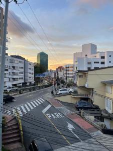 a city street with cars parked on the road at Hotel Portal Del Cerro Manizales in Manizales