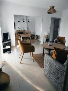 a living room with a couch and a table at La maison Françine in Sénas