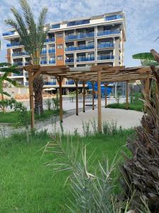 a building on the beach with a pavilion in front of it at Modern, Pool with slide,150m to beach in Alanya