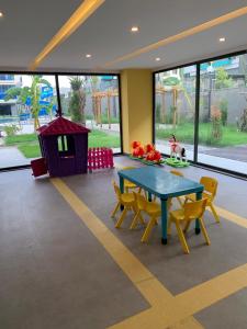 a dining room with a table and chairs and a dog house at Modern, Pool with slide,150m to beach in Alanya