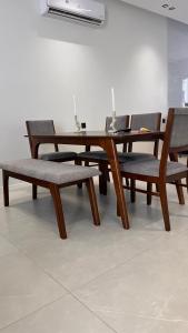a wooden table and benches with a table and chairs at شاليه بيرلا in Jeddah