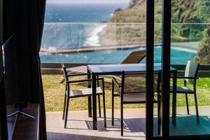 a table and chairs with a view of the ocean at GuestReady - Stay with stunning views in Santa Cruz
