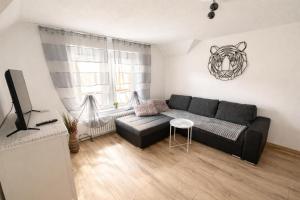 a living room with a couch and a table at Ferienwohnung AyNa 3, direkt an der Schweizer Grenze in Bad Säckingen