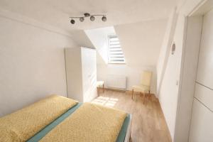 a small bedroom with a bed and a chair at Ferienwohnung AyNa 3, direkt an der Schweizer Grenze in Bad Säckingen