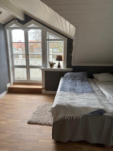 a bedroom with a large bed and two windows at Marstrand in Marstrand +19 photos