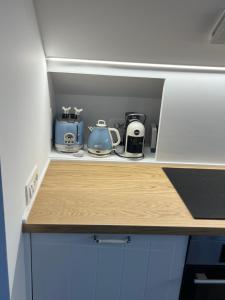 a cupboard with various appliances sitting on top of it at Casa Giardino Vista Mare in Ventimiglia