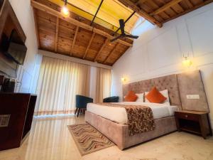 a bedroom with a bed and a television in a room at Hushvan Resorts in Devaprayāg