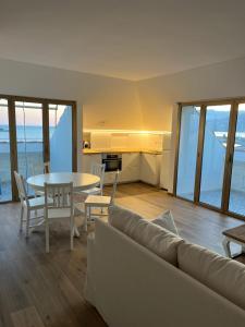 a living room with a couch and a table at Casa Giardino Vista Mare in Ventimiglia