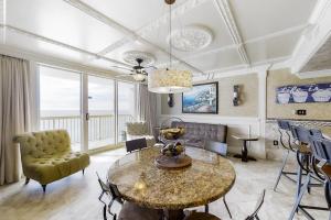 a living room with a table and a couch at Pelican Beach Resort 1502 in Destin