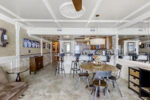 a kitchen and living room with a table and chairs at Pelican Beach Resort 1502 in Destin