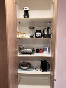 a kitchen pantry with a bunch of pots and pans at Ivan Suite More than accommodation an experience in Santiago
