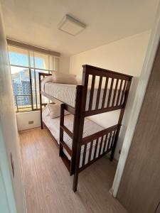 two bunk beds in a room with a window at Ivan Suite More than accommodation an experience in Santiago