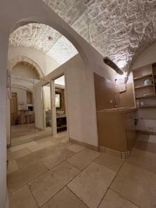 a bathroom with a stone ceiling and a sink at Opera Prima - Luxury Homes in Ceglie Messapica