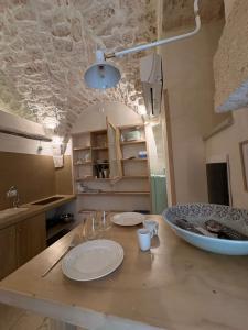 a kitchen with a table with plates on it at Opera Prima - Luxury Homes in Ceglie Messapica