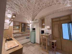 a kitchen with a blue refrigerator in a room at Opera Prima - Luxury Homes in Ceglie Messapica