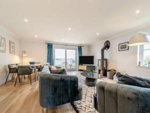 a living room with two couches and a dining room at Springbank in Brodick