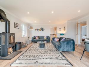 a living room with two couches and a fireplace at Springbank in Brodick