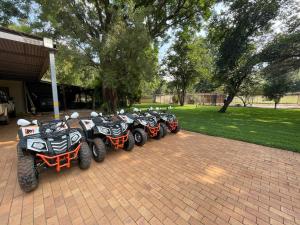 a row of motorcycles parked in a parking lot at Bush Lovers Lodge in Modimolle