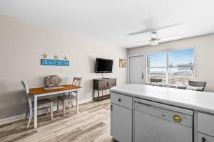 a kitchen and dining room with a table and a dining room at Tropical Isle #205 in Fort Walton Beach