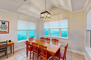 a dining room with a wooden table and chairs at Serenity Now in St. George Island