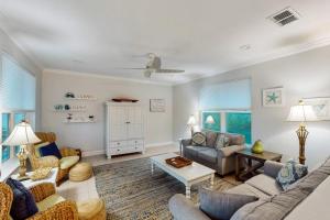 a living room with a couch and a table at Serenity Now in St. George Island