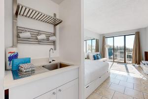 a kitchen with a sink and a bed in a room at Pirates Bay B314 in Fort Walton Beach +27 photos