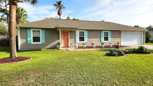 a house with a palm tree in a yard at Poolside Palms Paradise in Navarre +20 photos