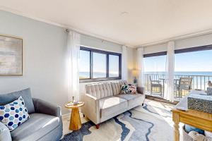 a living room with a couch and a large window at Sundunes 121 in Navarre