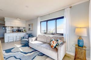 a living room with a couch and a large window at Sundunes 121 in Navarre