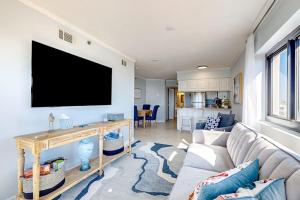 a living room with a couch and a flat screen tv at Sundunes 121 in Navarre